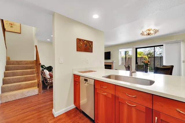 a large kitchen with wooden floor and a sink