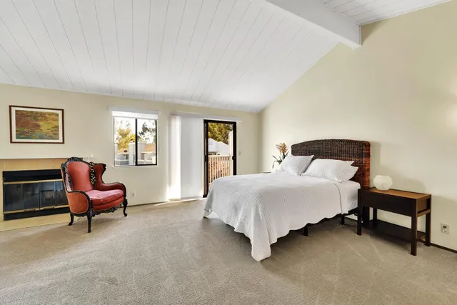 a bedroom with a bed chair and window