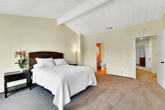 a bedroom with a bed and a couch