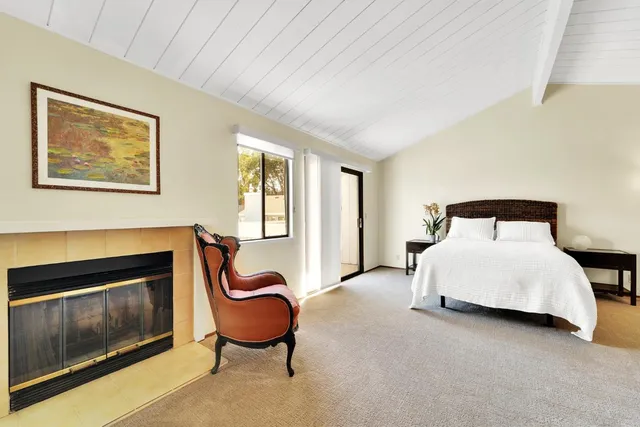 a bedroom with a bed and a fireplace