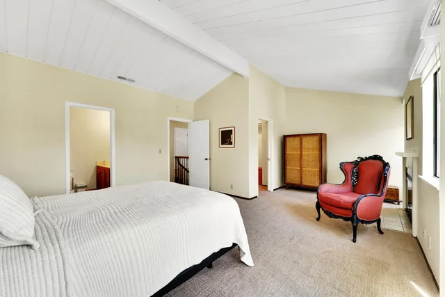 a spacious bedroom with a bed and a couch