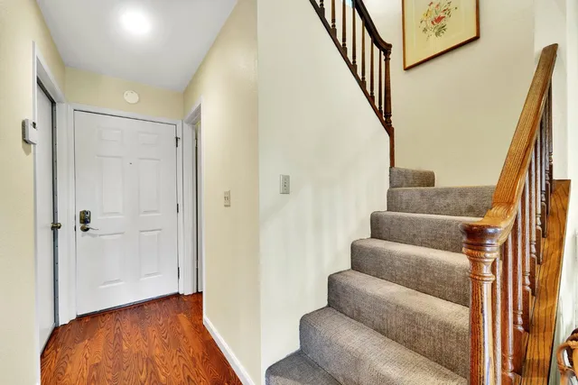 a view of entryway with wooden floor and stairs