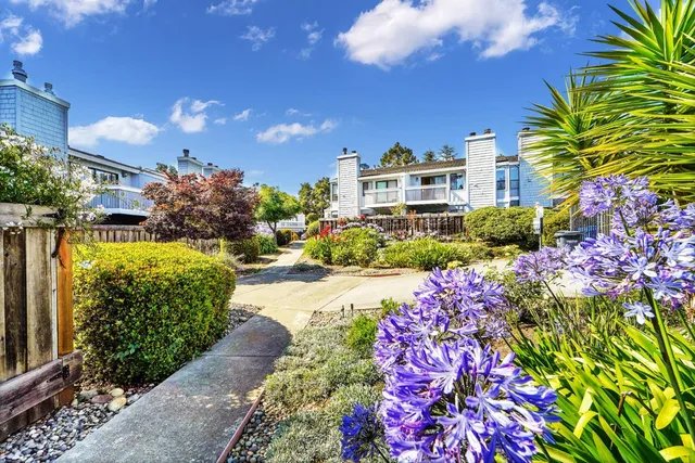 a view of a multi story house with a yard