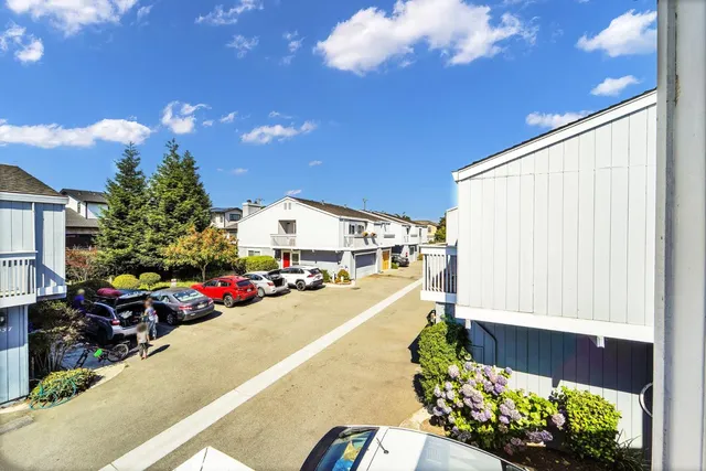 a view of a patio with table and chairs potted plants