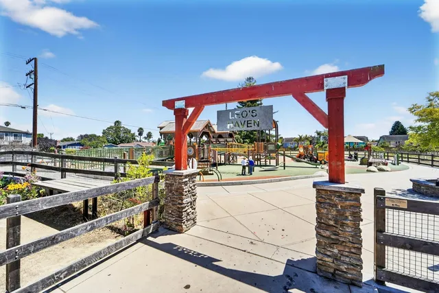 a view of a living room with a floor to ceiling window and wooden floor