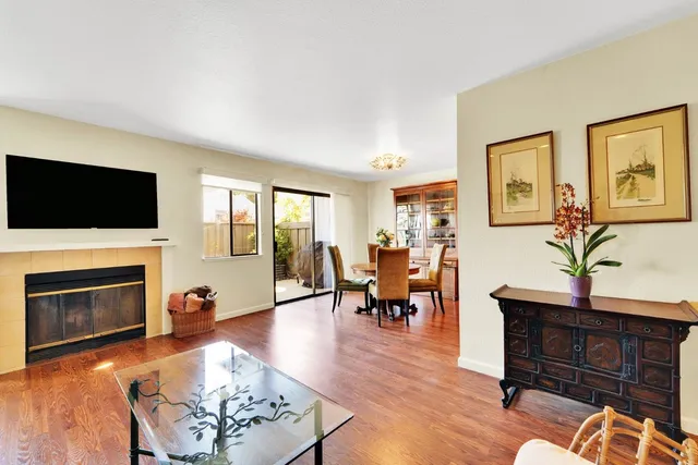 a living room with furniture a fireplace and a flat screen tv