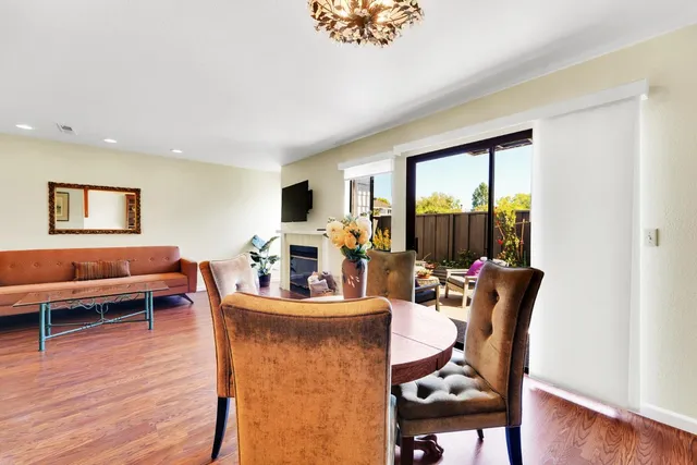 a living room with furniture a flat screen tv and a large window