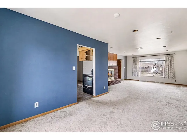 a view of a livingroom with an empty space and a ceiling fan