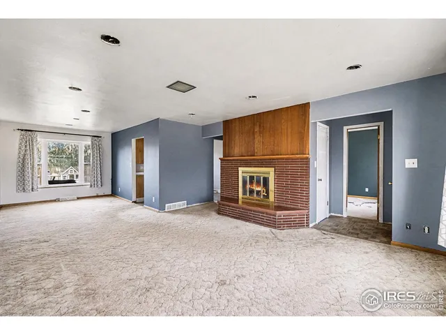 a view of a livingroom with an empty space and window
