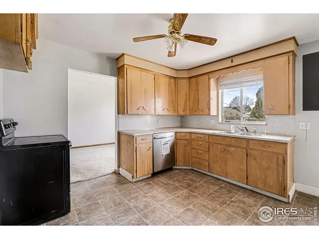 a kitchen with a refrigerator and a sink