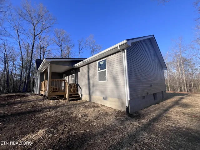 a backyard of a house with large trees