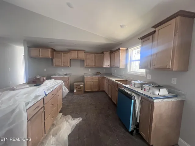 a kitchen with wooden cabinets and a sink