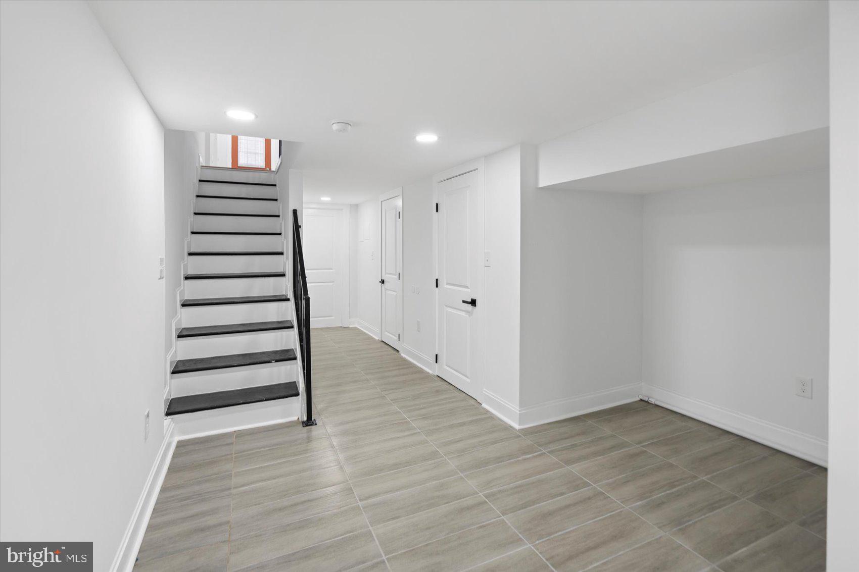 2440 East Biddle Street Baltimore, MD 21213 - Photo 13 of 35 a view of a hallway with stairs and a window