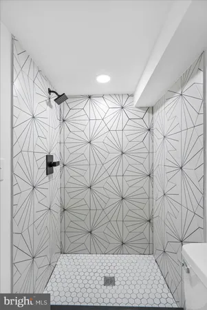 a view of room with wooden floor and white walls