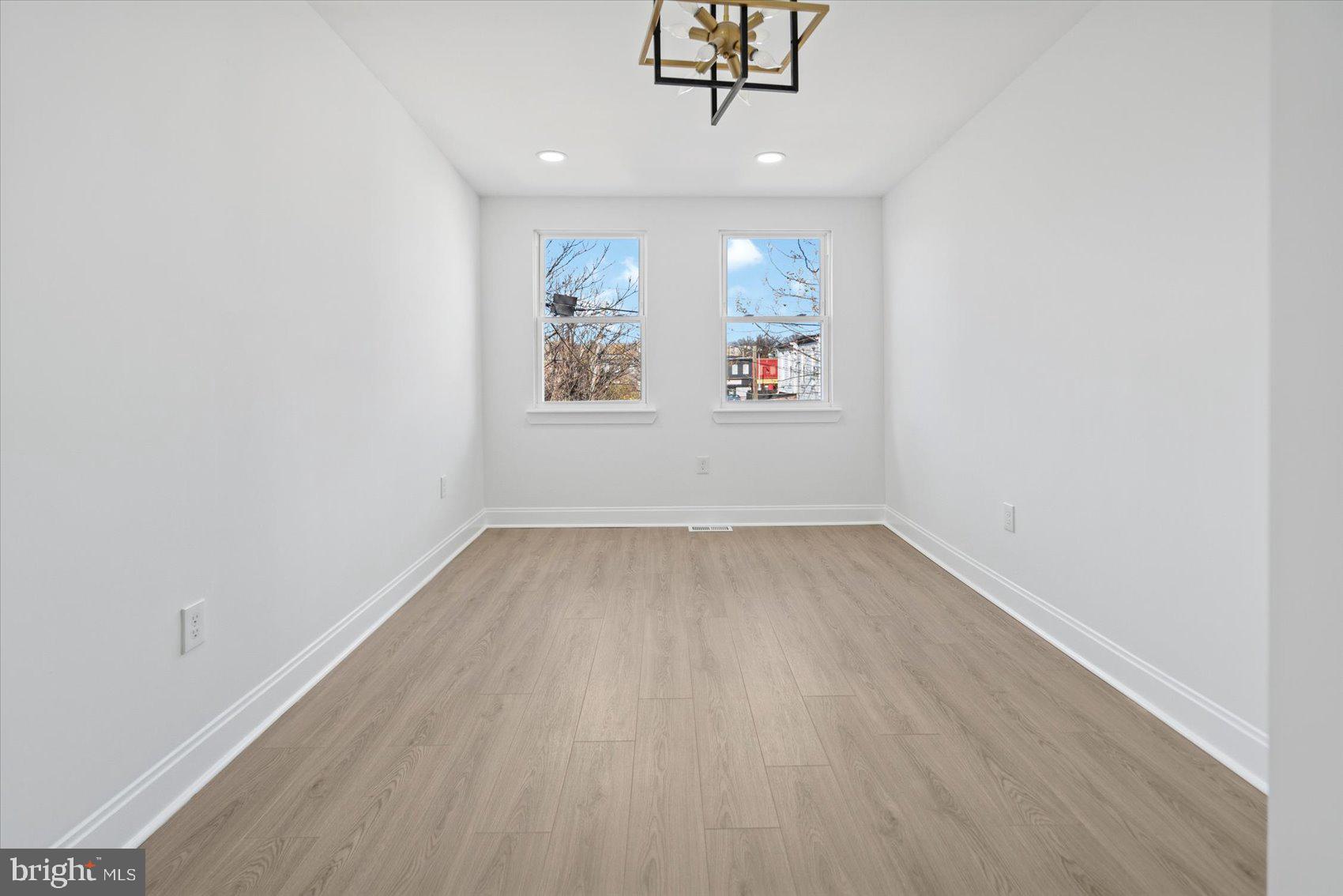 2440 East Biddle Street Baltimore, MD 21213 - Photo 20 of 35 wooden floor in an empty room with a window