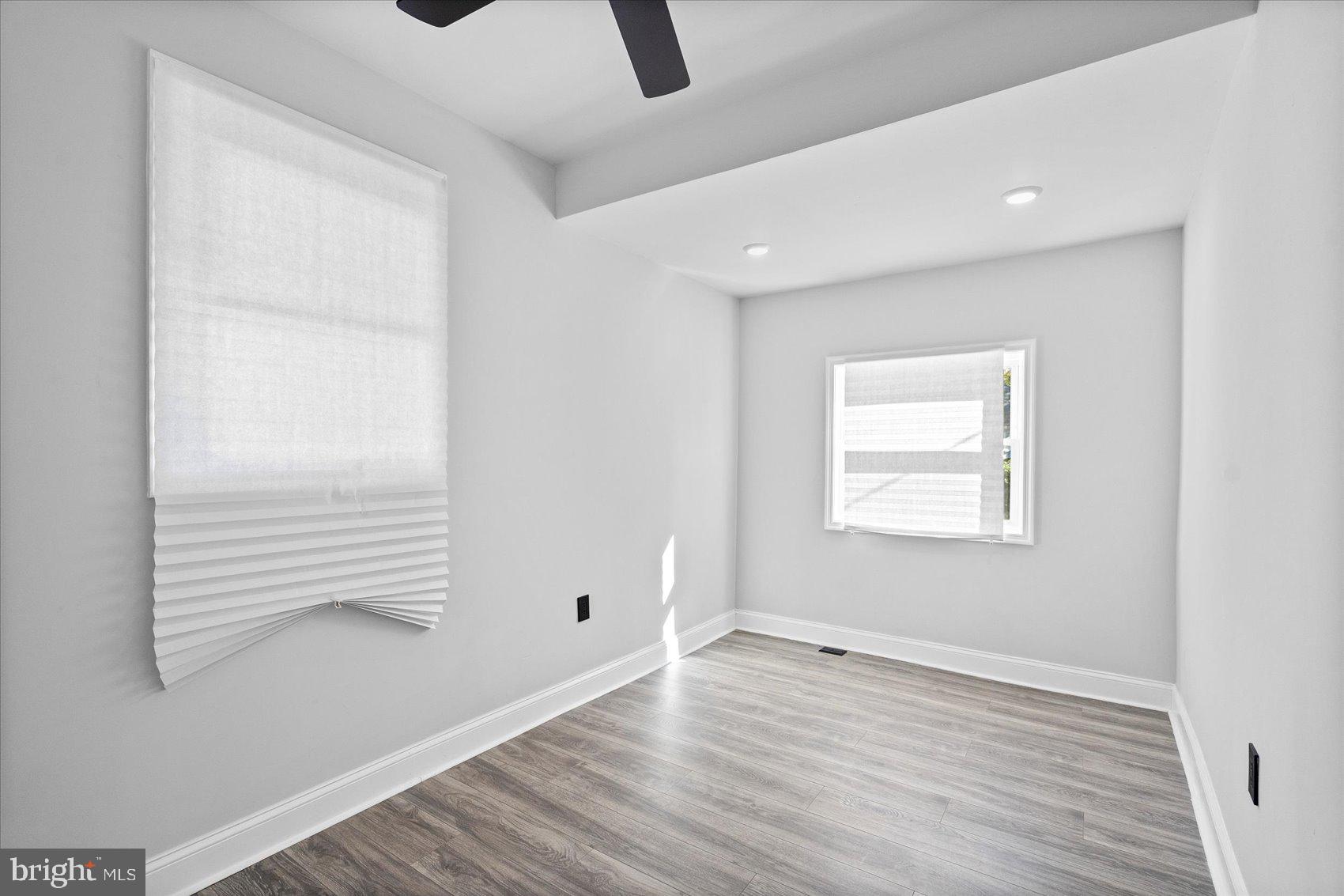 2440 East Biddle Street Baltimore, MD 21213 - Photo 21 of 35 an empty room with wooden floor and windows