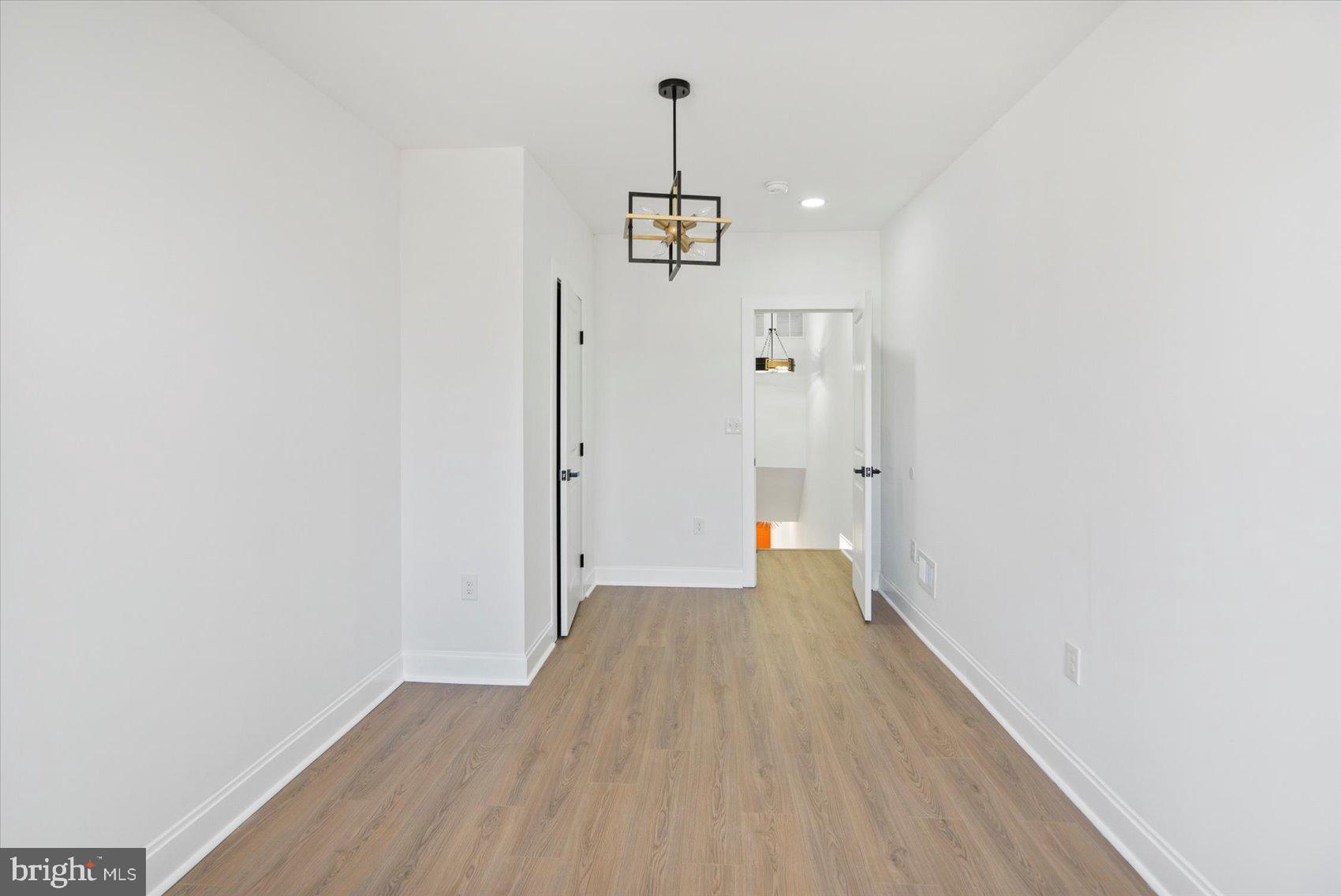 2440 East Biddle Street Baltimore, MD 21213 - Photo 22 of 35 a view of a hallway with wooden floor and staircase