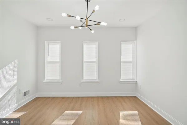 a view of a room with a sink and a mirror