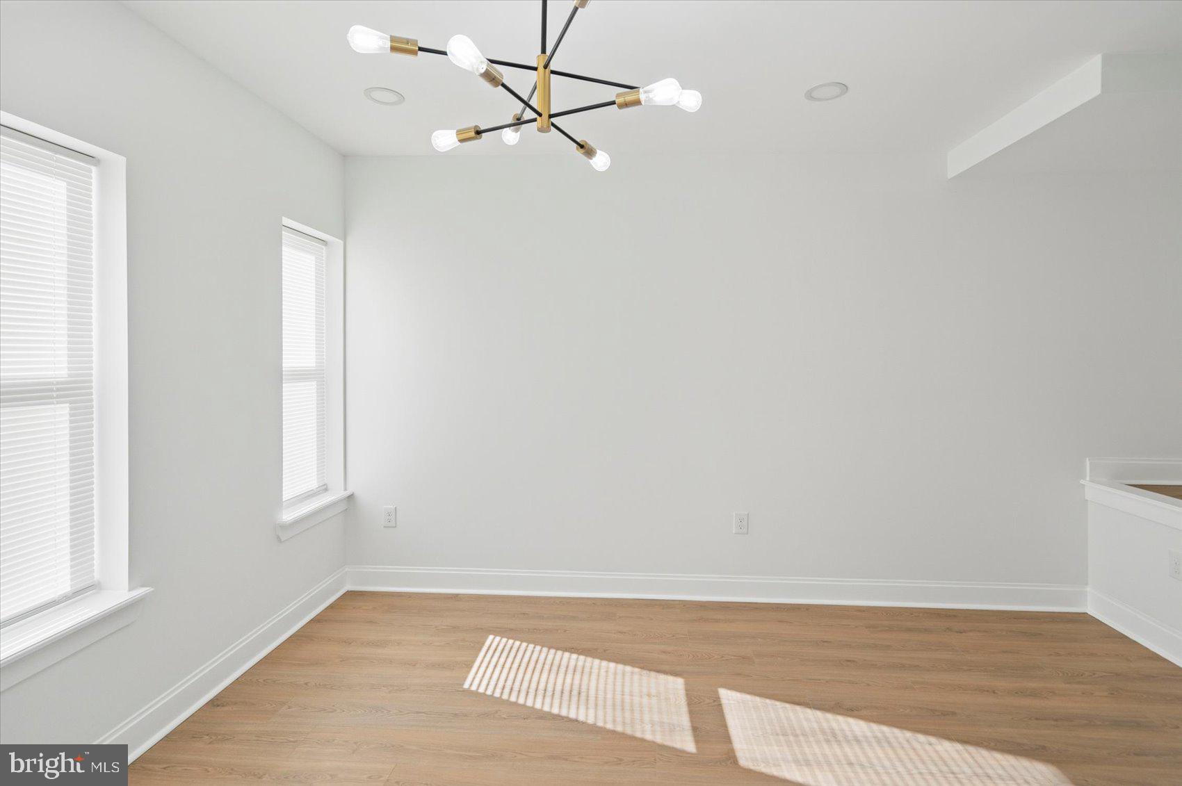2440 East Biddle Street Baltimore, MD 21213 - Photo 25 of 35 a view of an empty room with wooden floor and a window
