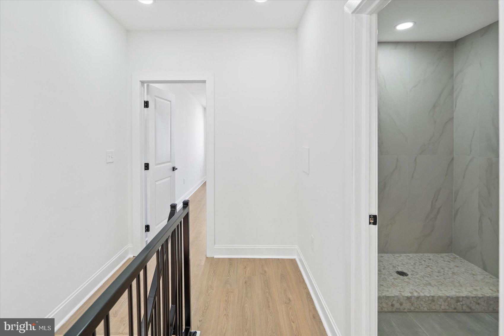2440 East Biddle Street Baltimore, MD 21213 - Photo 26 of 35 a view of a hallway with wooden floor and staircase