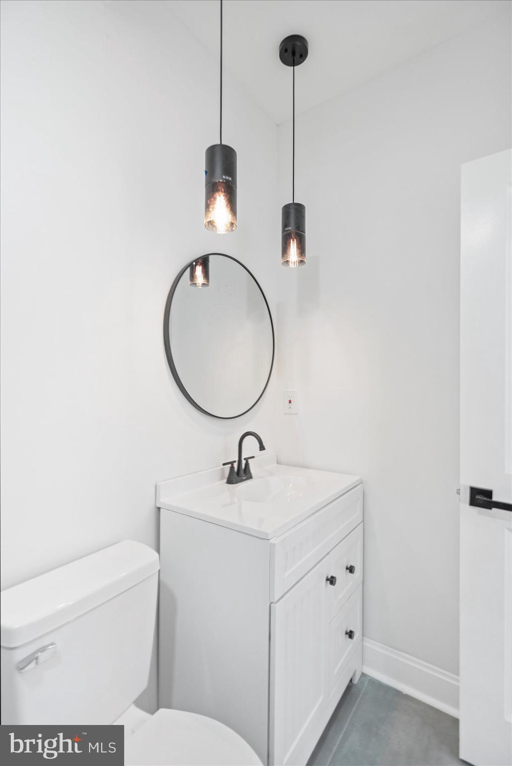 2440 East Biddle Street Baltimore, MD 21213 - Photo 30 of 35 a bathroom with a sink a toilet and a mirror
