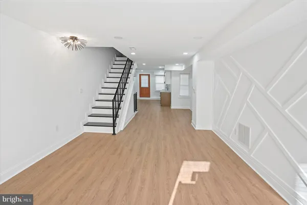 a view of entryway with stairs and wooden floor