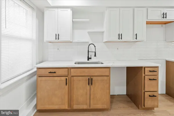 a kitchen with cabinets appliances and a window