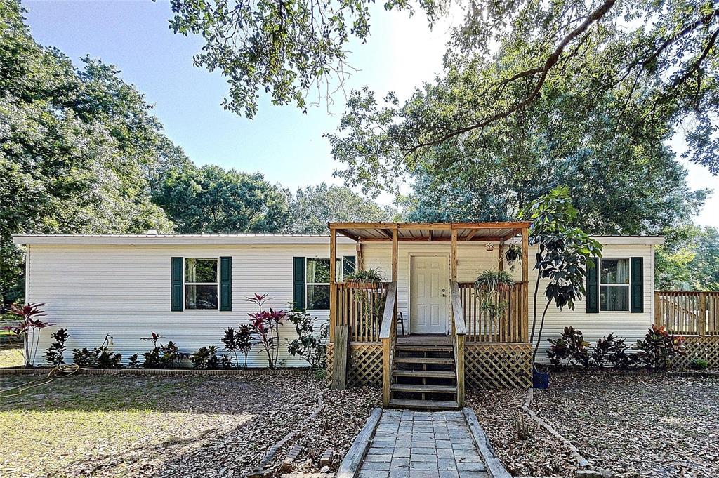 8834 Carey Road Lithia, FL 33547 - Photo 1 of 1 a view of a house with backyard and wooden fence