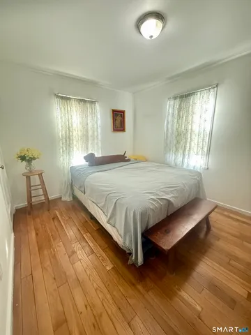 a bedroom with a bed and a television