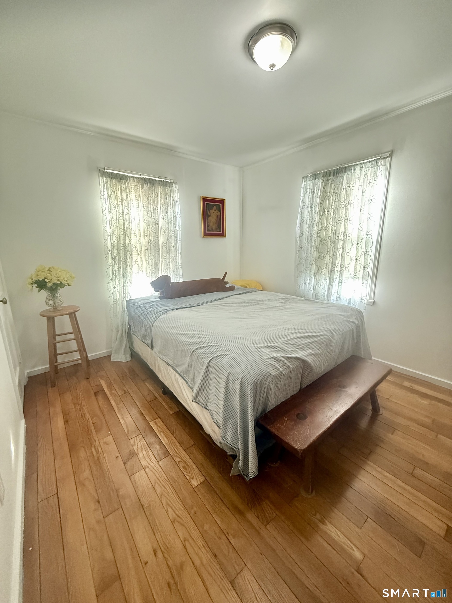 92 Garfield Road Bristol, CT 06010 - Photo 12 of 24 a bed sitting in a spacious bedroom next to a window and a chair