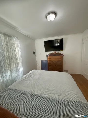 a bedroom with two beds and painting on the wall