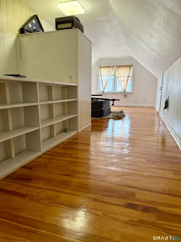 a room with wooden floor and window