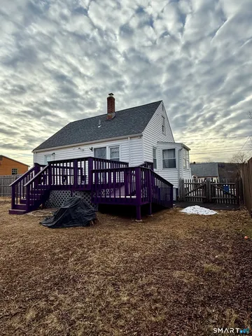 a car parked in front of a house with a yard