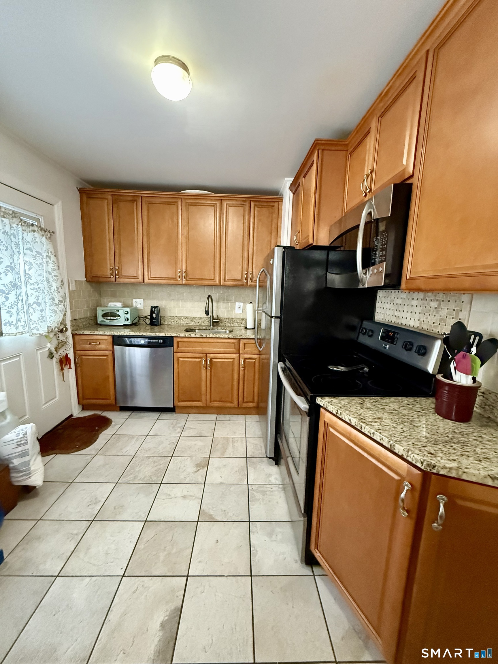 92 Garfield Road Bristol, CT 06010 - Photo 6 of 24 a kitchen with stainless steel appliances granite countertop a sink stove and cabinets