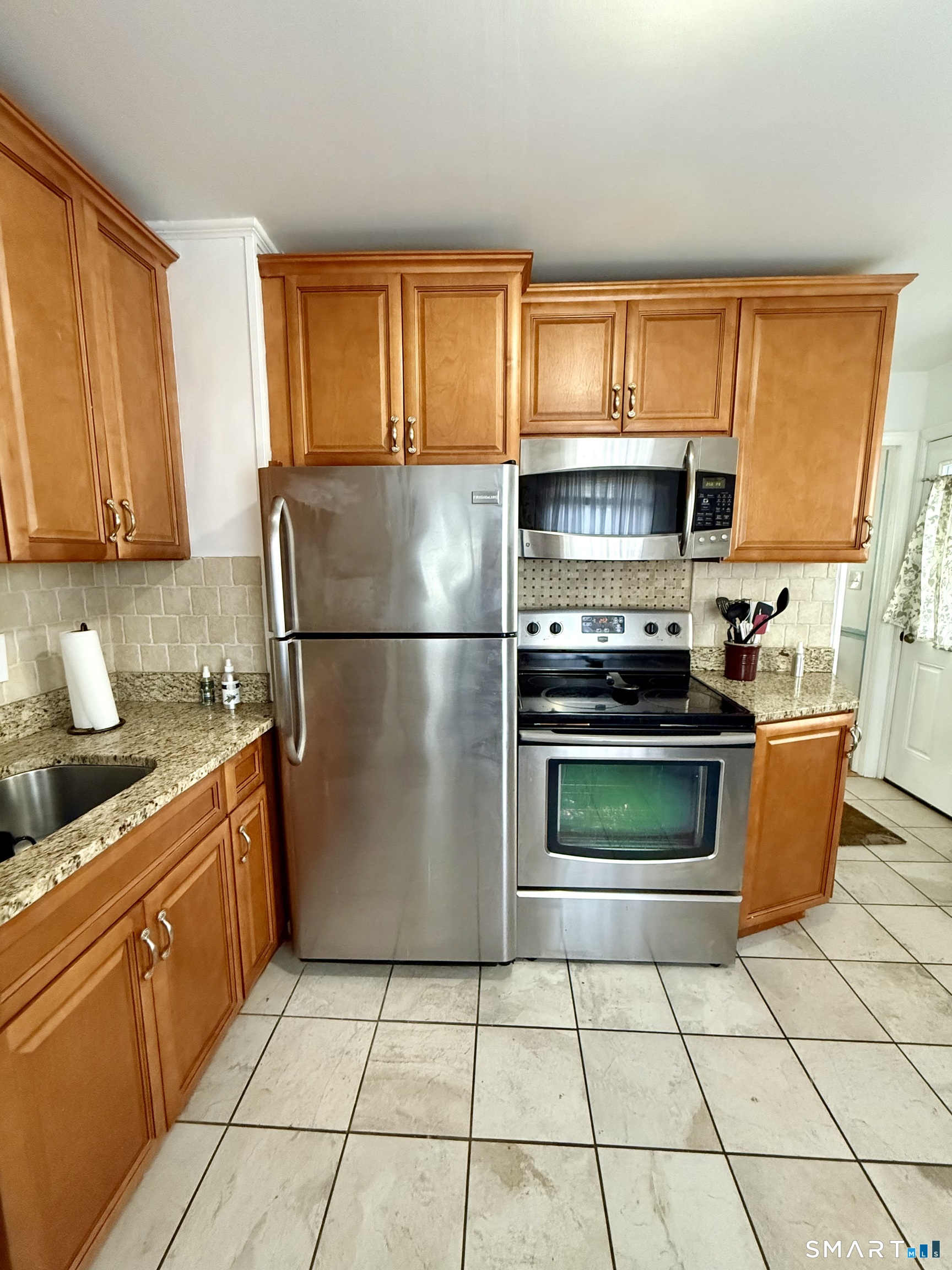 92 Garfield Road Bristol, CT 06010 - Photo 8 of 24 a kitchen with granite countertop a refrigerator stove top oven and sink