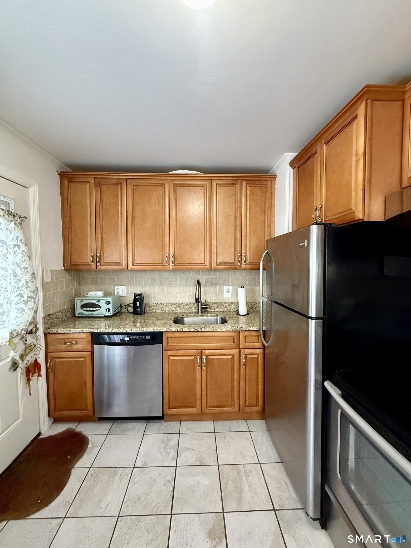 92 Garfield Road Bristol, CT 06010 - Photo 9 of 24 a kitchen with stainless steel appliances granite countertop a refrigerator sink and stove