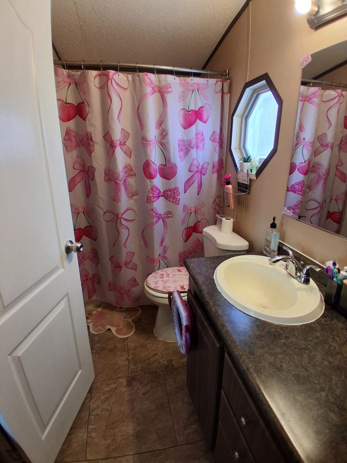130 Gato Road Cedar Creek, TX 78612 - Photo 17 of 23 Full bathroom with vanity, a shower with shower curtain, and a textured ceiling
