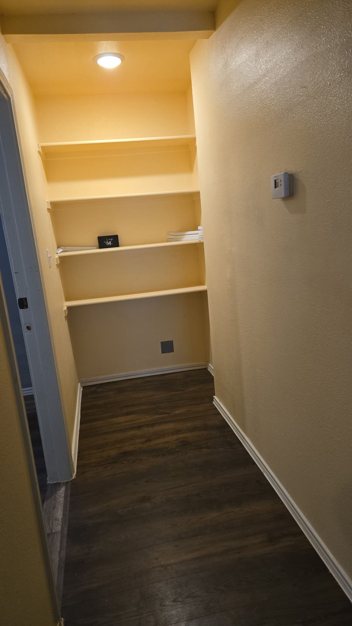 130 Gato Road Cedar Creek, TX 78612 - Photo 22 of 23 Hallway featuring dark wood-type flooring, beamed ceiling, built in shelves, recessed lighting, and a textured wall