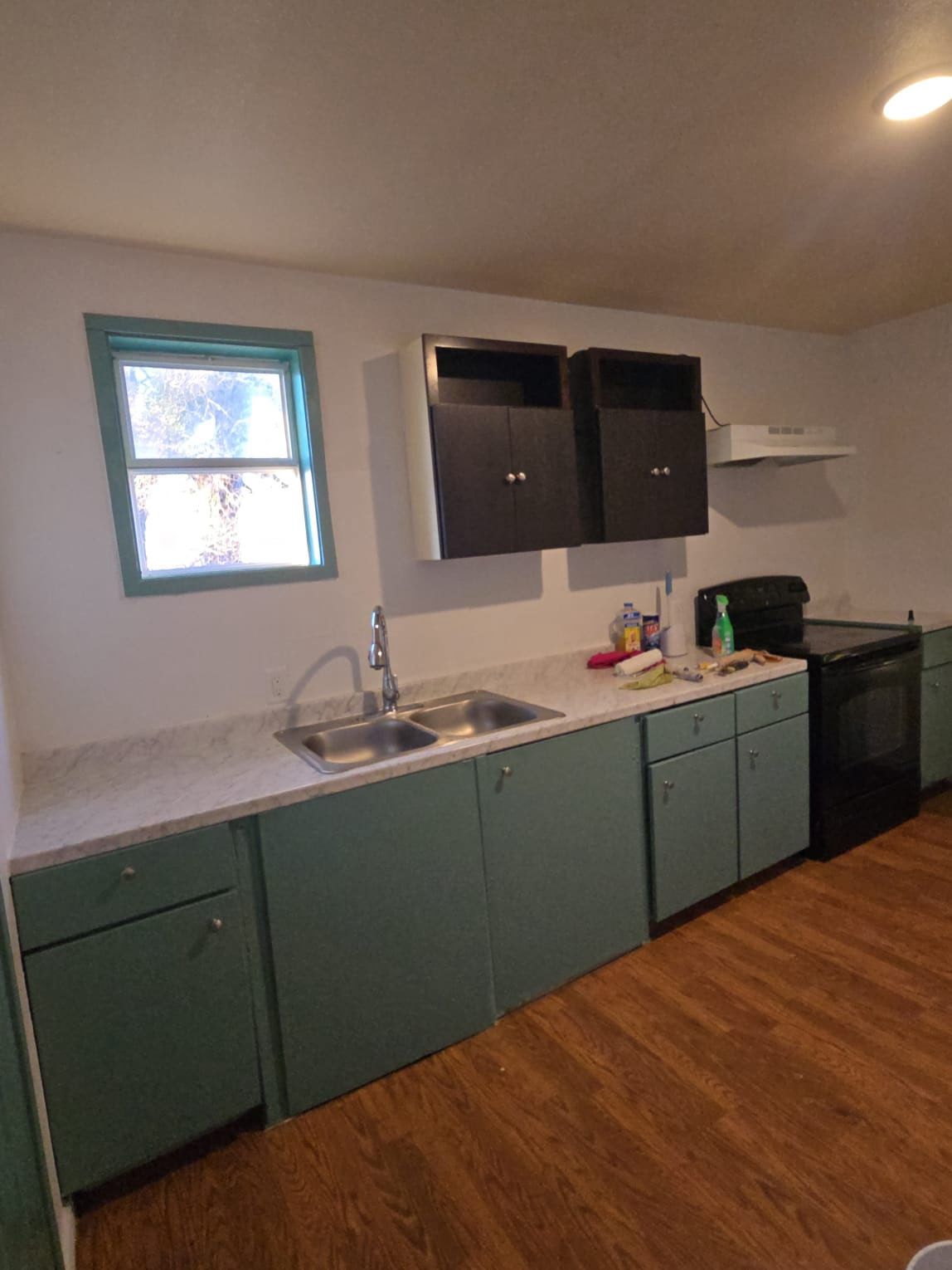 130 Gato Road Cedar Creek, TX 78612 - Photo 6 of 23 Kitchen with light countertops, electric range, dark wood-style floors, and green cabinetry