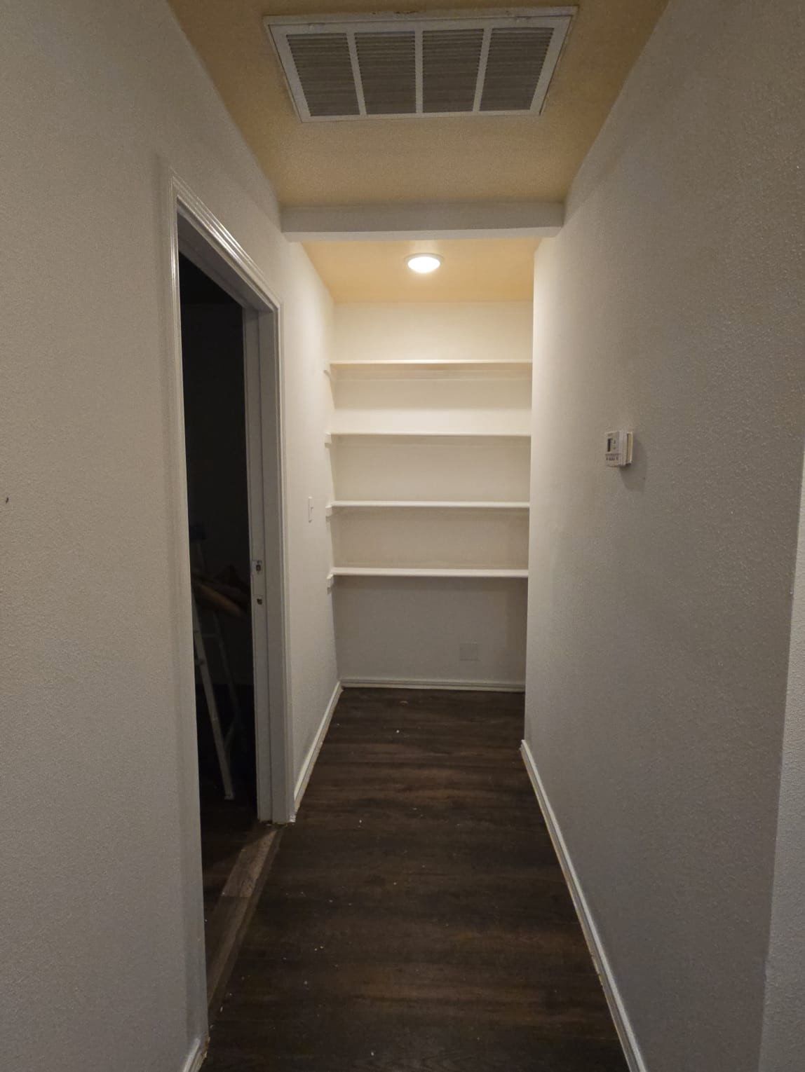 130 Gato Road Cedar Creek, TX 78612 - Photo 10 of 23 Corridor featuring baseboards and dark wood finished floors