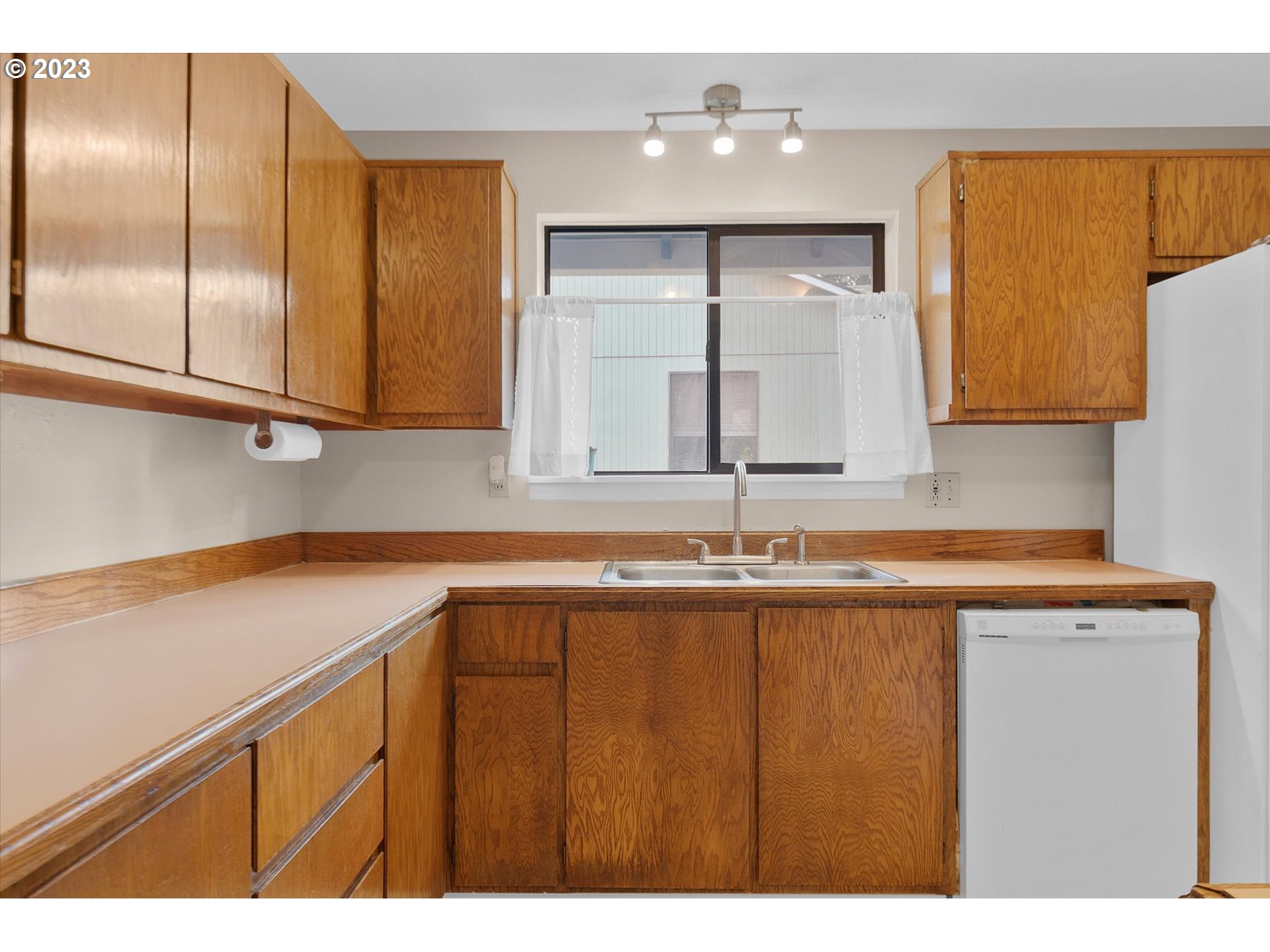 39935 Davis Street Sandy, OR 97055 - Photo 11 of 32 a kitchen with a sink a refrigerator and cabinets