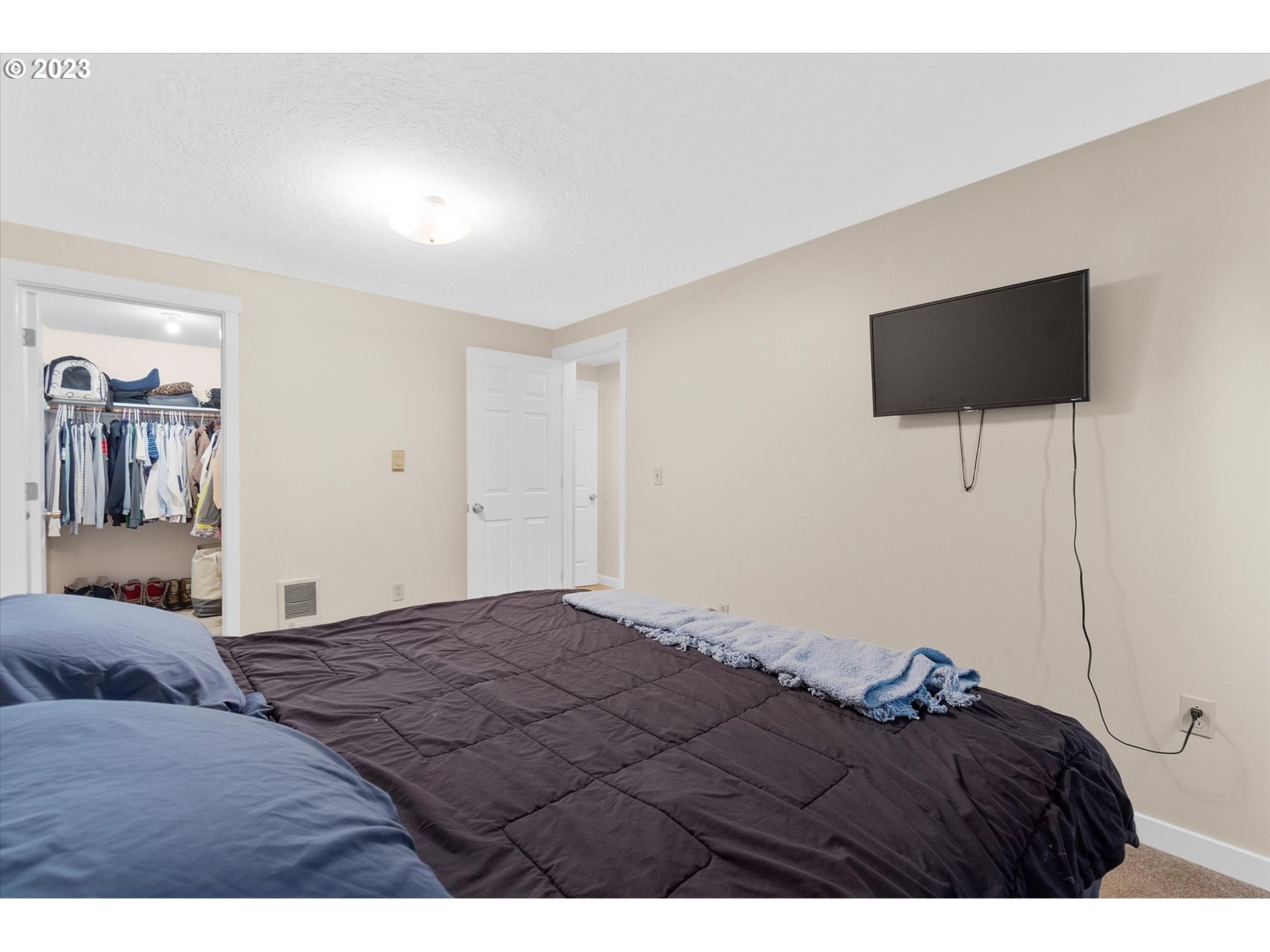 39935 Davis Street Sandy, OR 97055 - Photo 19 of 32 a bedroom with a bed and a flat screen tv