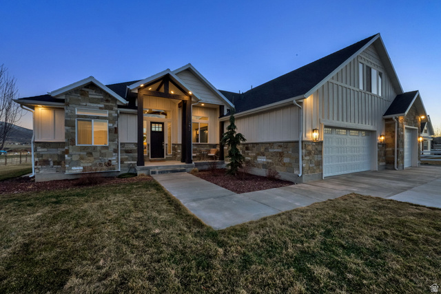 352 East Boulderville Road Oakley, UT 84055 - Photo 6 of 62 Modern inspired farmhouse with board and batten siding, stone siding, a front yard, and concrete driveway