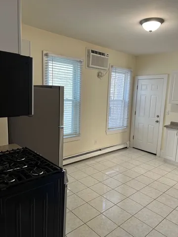 a kitchen with a refrigerator and a stove