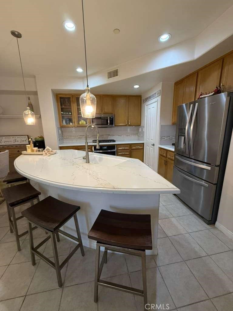 2931 Esperanza Way, Unit B Simi Valley, CA 93063 - Photo 5 of 49 a kitchen with a dining table chairs sink and refrigerator