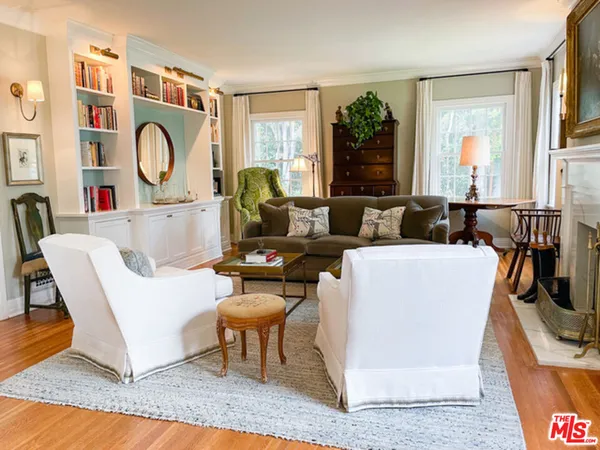 a living room with furniture a window and a table
