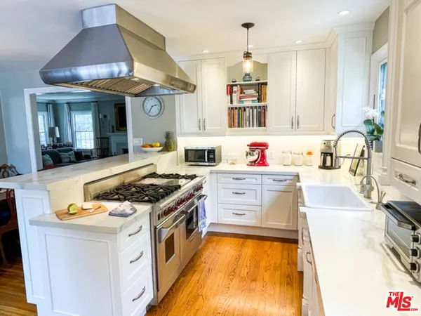 a kitchen with a stove a sink and a refrigerator