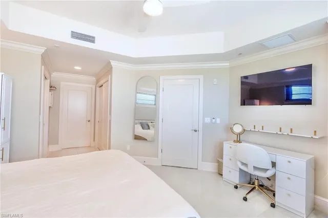 a spacious bedroom with a bed and a mirror