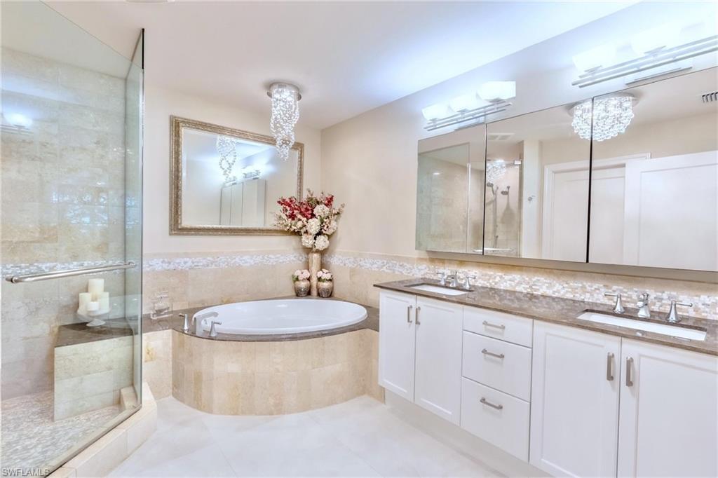 9115 Strada Place, Unit 5317 Naples, FL 34108 - Photo 11 of 29 a bathroom with a granite countertop sink mirror vanity and toilet