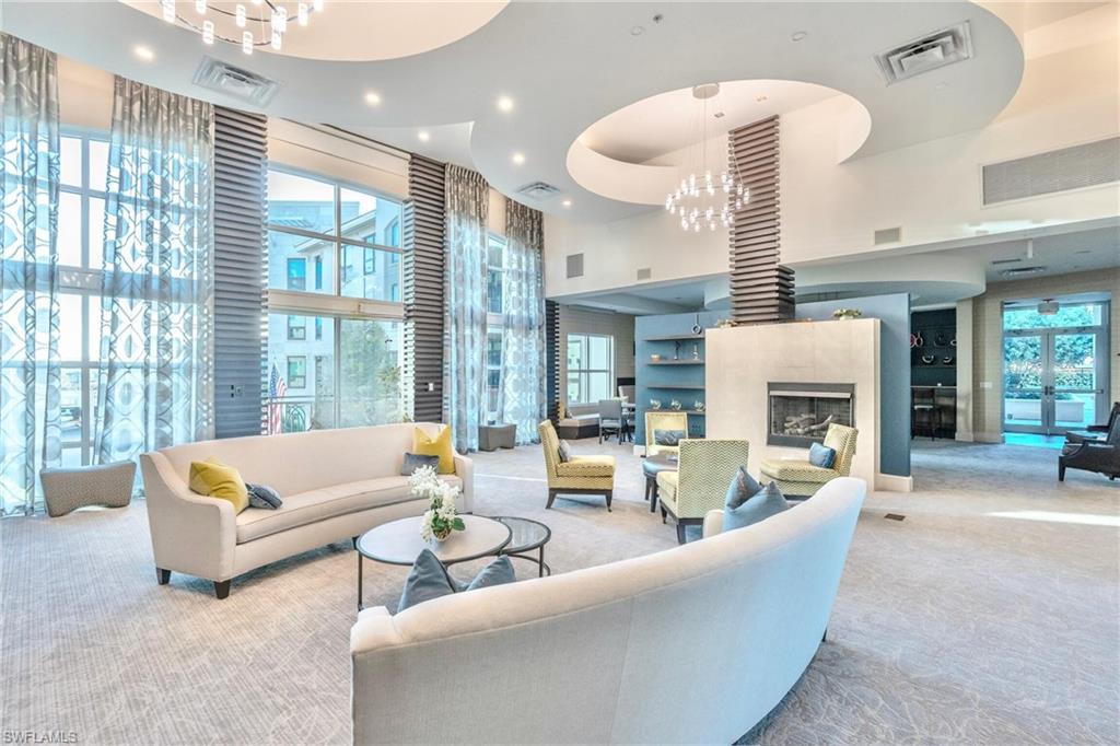 9115 Strada Place, Unit 5317 Naples, FL 34108 - Photo 26 of 30 a living room with furniture and a fireplace